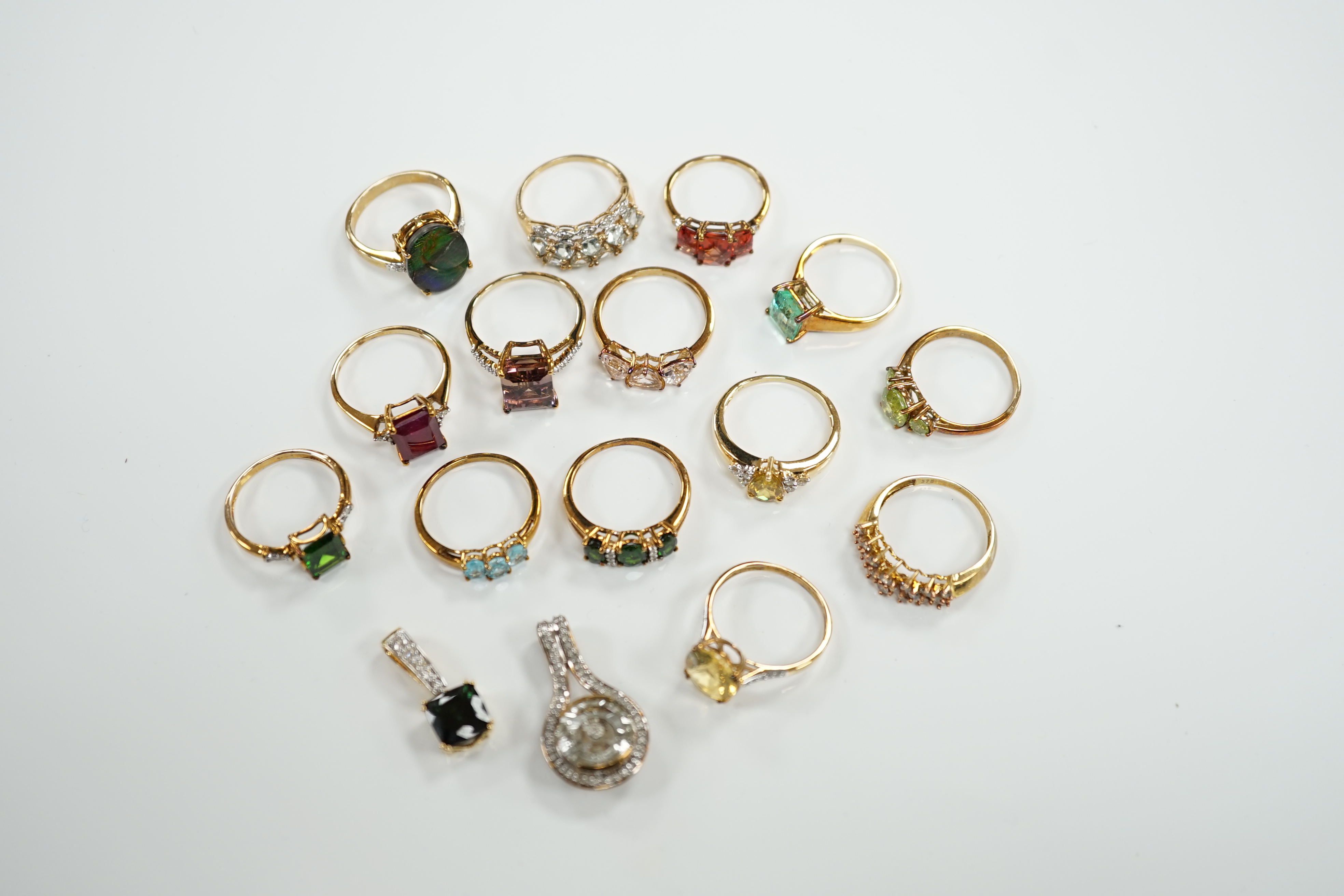 Thirteen assorted modern 9ct gold of 9k and gem set dress rings and a 9ct gold and gem set pendant, gross weight 40.2 grams, together with an 18ct gold, gem and diamond chip set target pendant and an 18ct gold and gem se